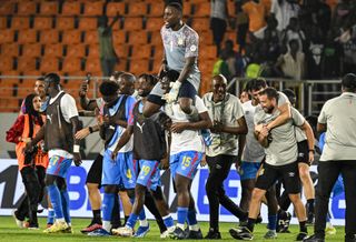 DR Congo goalkeeper Lionel Mpasi is lifted by one of his team-mates after scoring the winning penalty against Egypt in the Africa Cup of Nations in January 2024.