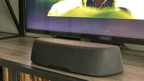Soundbar on tabletop in front of TV screen 