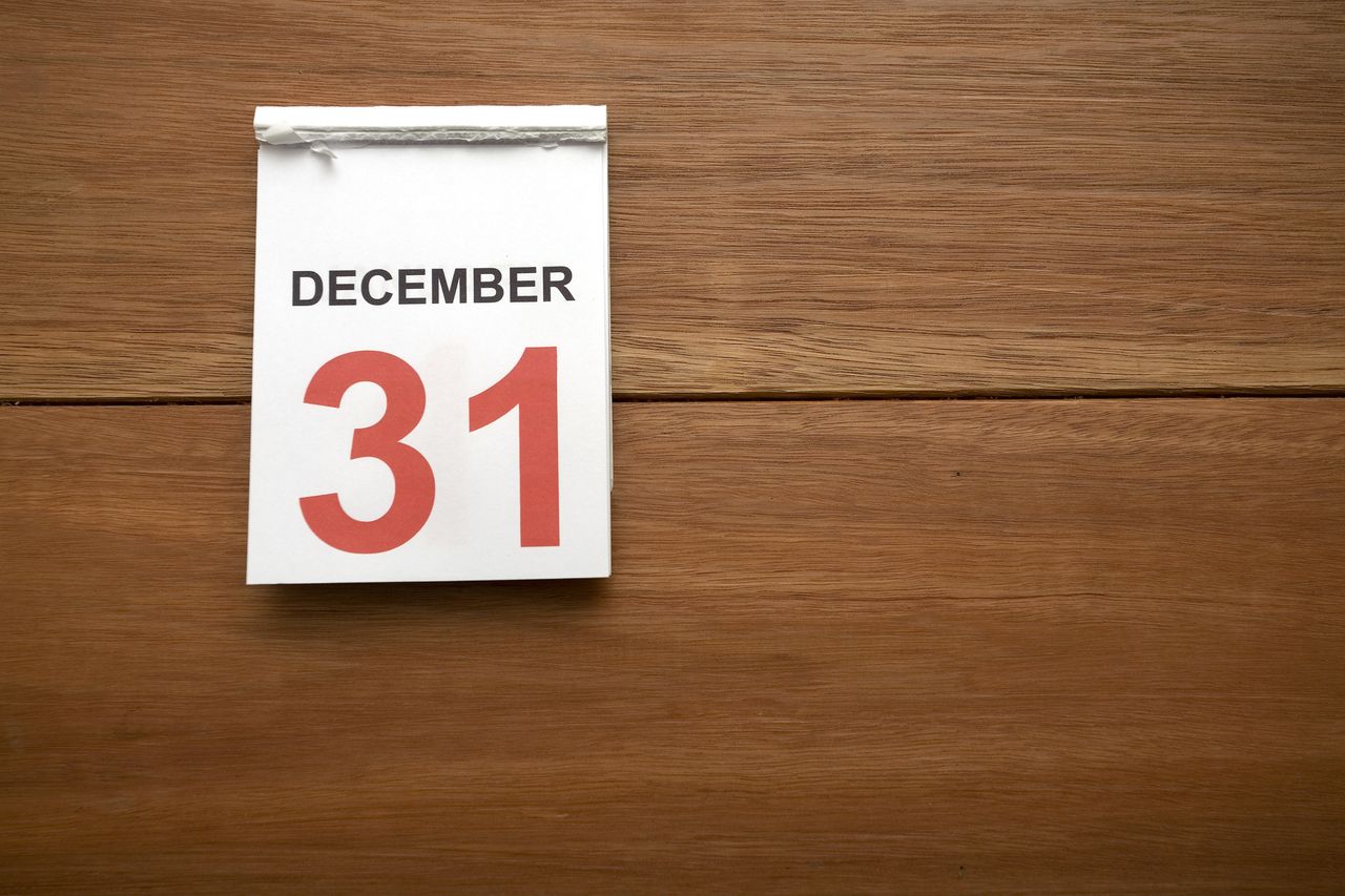 image of a December 31 calendar page on wooden table