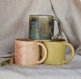 three ceramic glazed mugs