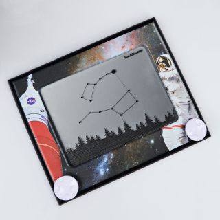 The NASA-Inspired Limited Edition Etch A Sketch features a frame depicting NASA's Artemis program Space Launch System rocket and a spacesuited astronaut with a starry backdrop.