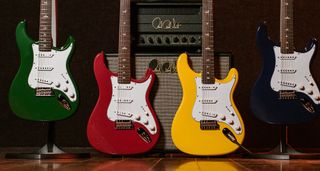 PRS SE Silver Sky 2025: refreshed for the brand's 40th anniversary, the SE Silver Sky John Mayer signature model is pictured in its new Laurel Green, Derby Red, Dandy Lion and Trad Blue finishes. A PRS tube amp and speaker cabinet is in the background.