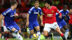 Marouane Fellaini of Manchester United competes with Gary Cahill of Chelsea