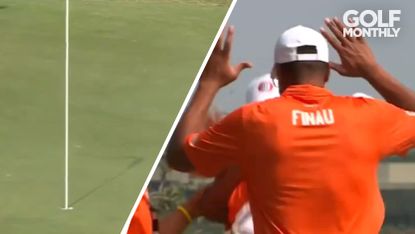 Tony Finau high fives Emery Johnson after an ace