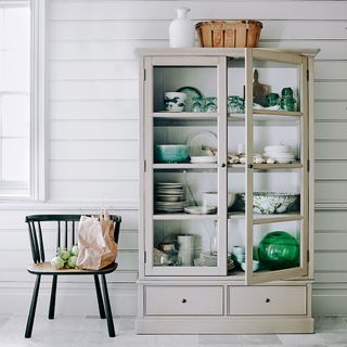 white room with cupboard and cutlery