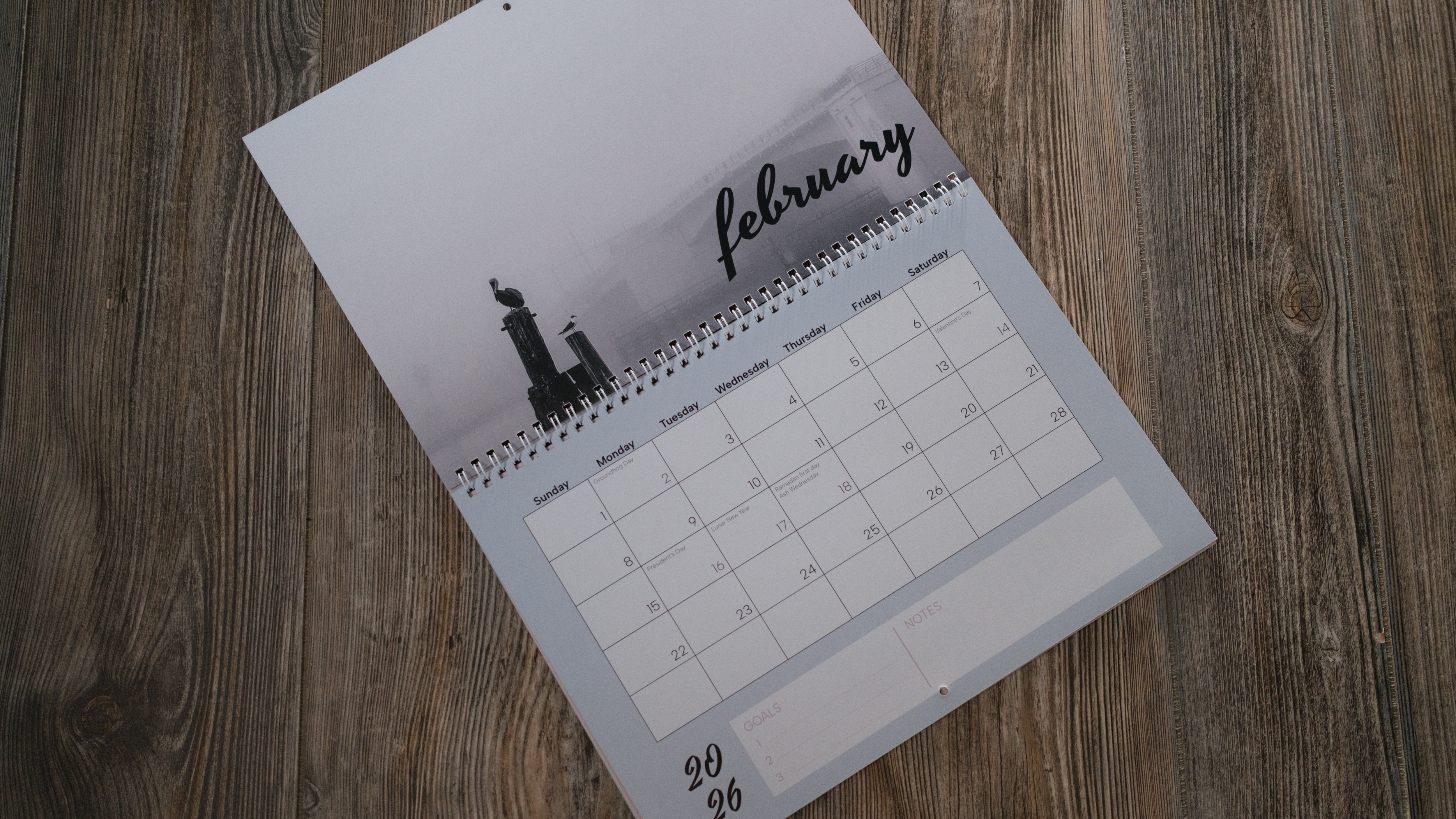 A photo calendar from Vistaprint on a wood background