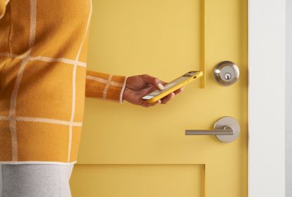 Level Touch smart lock installed on bright yellow front door