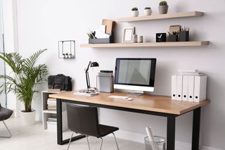 Desk with computer and office supplies in home office