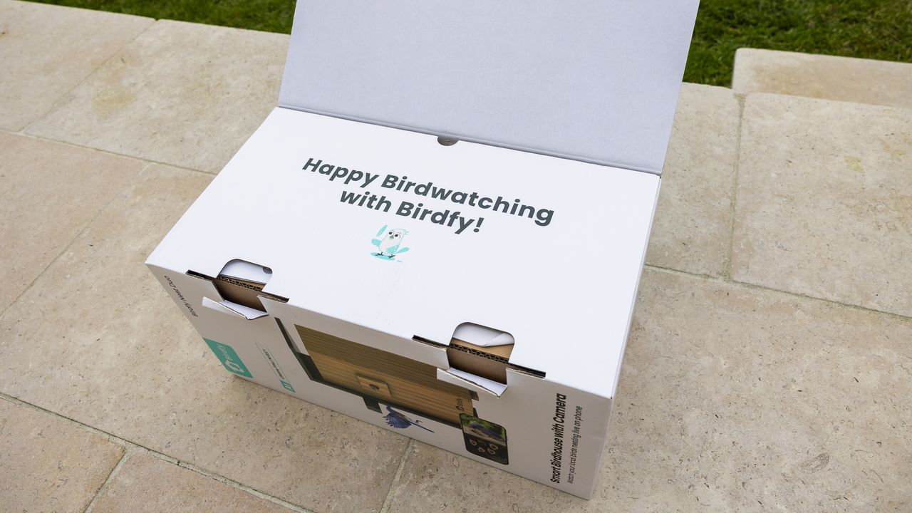 The Birdfy Nest Duo box on a patio in a sunny garden
