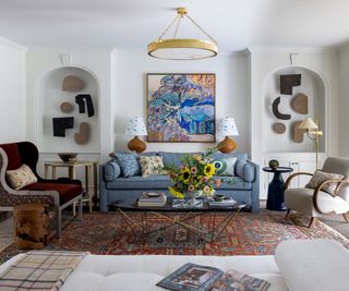 living room with wall sculptures in alcoves and blue sofa