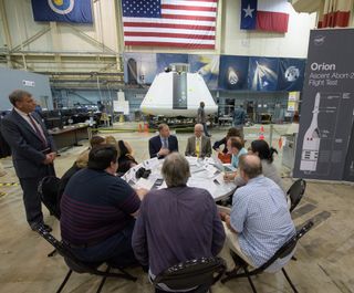 Jim Bridenstine, seated left, facing camera, and NASA Johnson Space Center Director Mark Geyer, seated right, facing camera, participate in a media roundtable that was held in front of the Orion test crew capsule for the Ascent Abort-2 (AA-2) test, on Aug. 2, 2018, at NASA's Johnson Space Center in Houston.