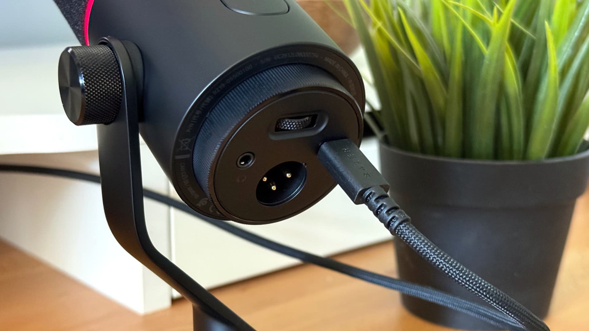 Razer Seiren V3 Pro microphone on wooden desk