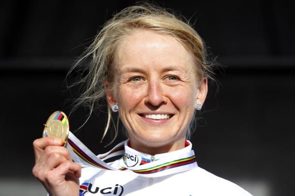 Emma Pooley (Great Britain) shows off her gold medal.