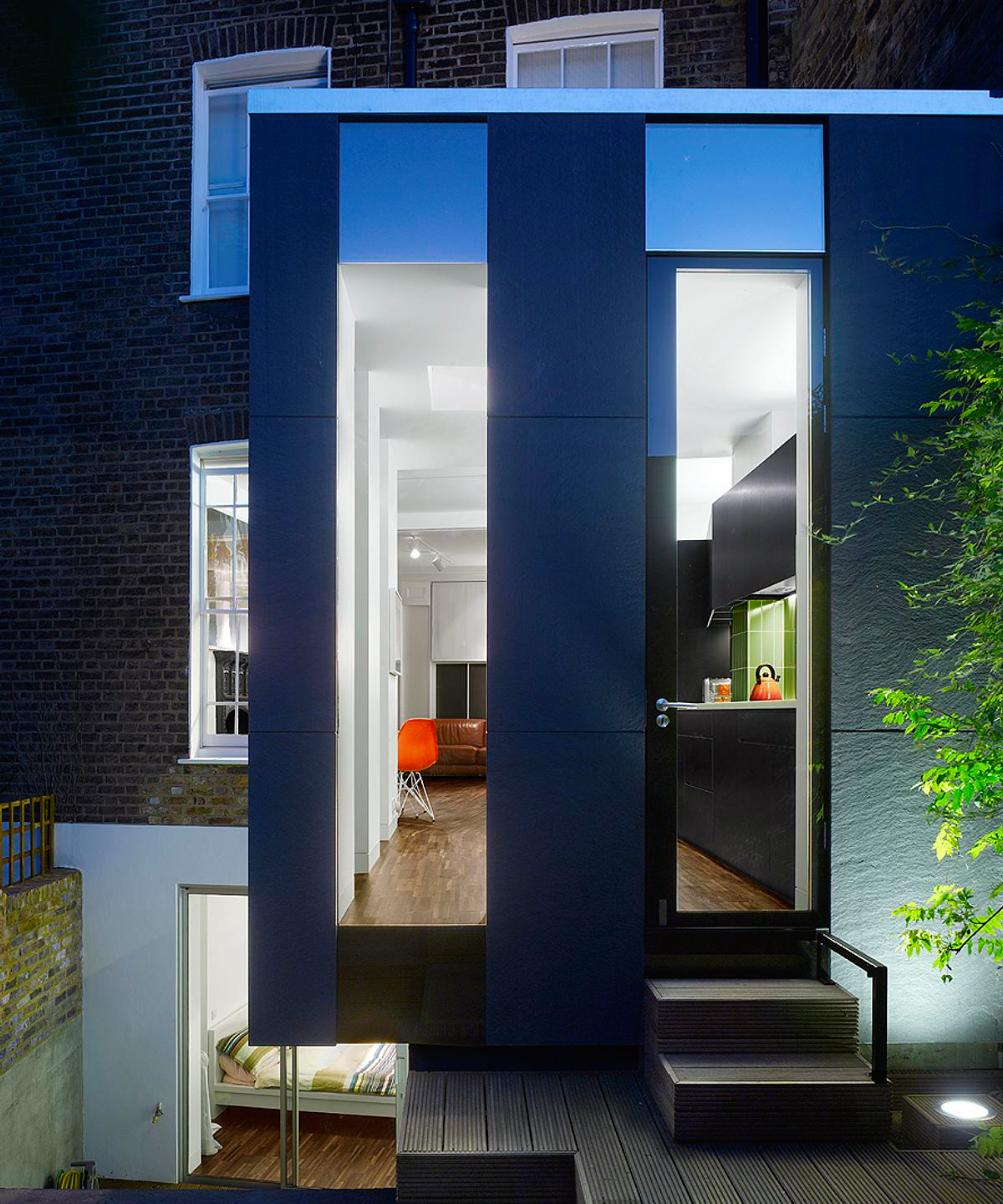 extension clad with large scale black riven slate tiles
