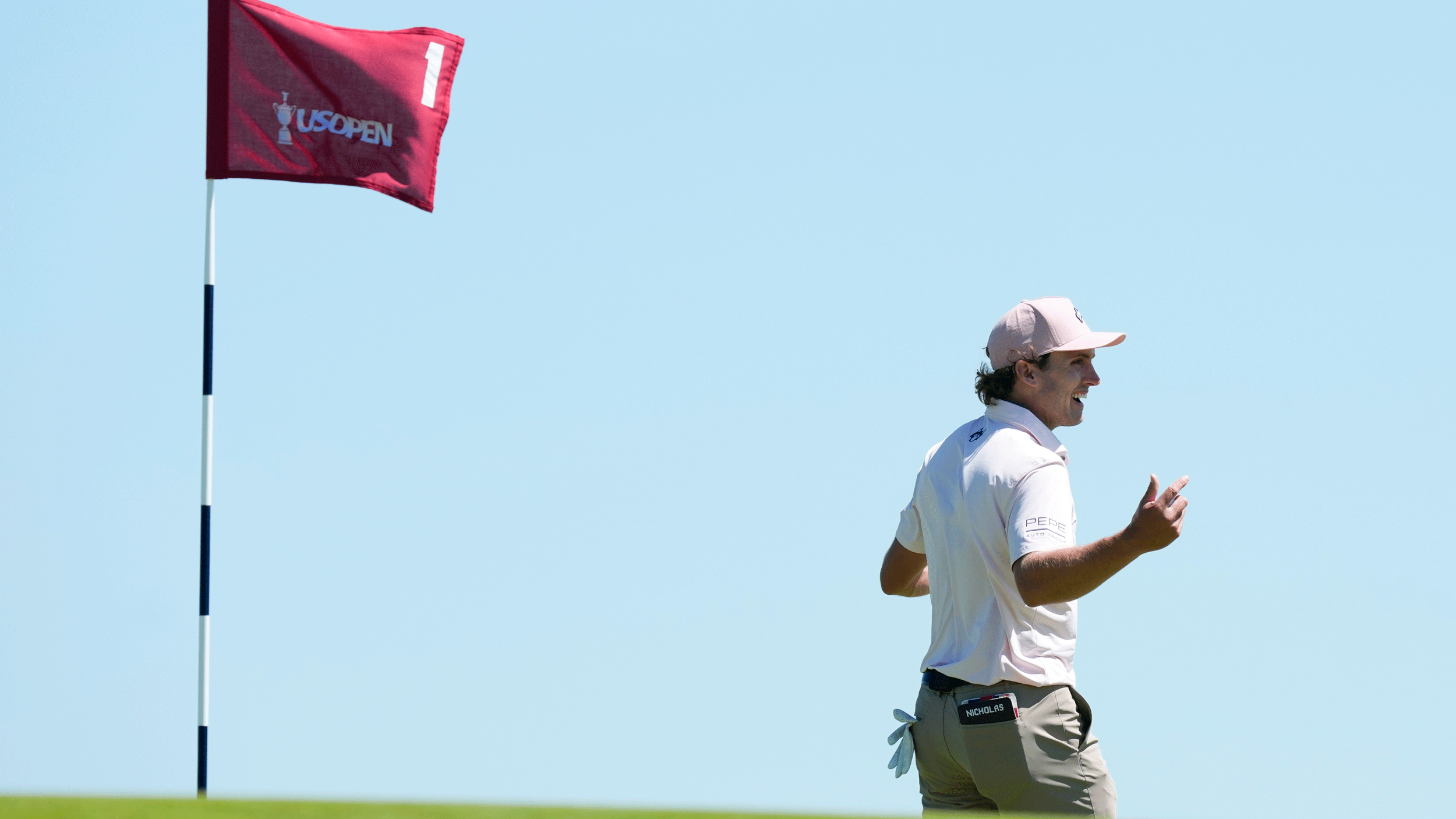 James Nicholas (right) and a US Open flag (left)