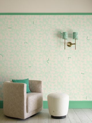 a wallpapered wall with green paint details