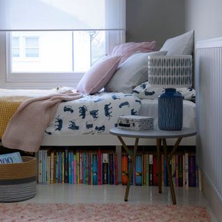 bedroom with books stored under cot