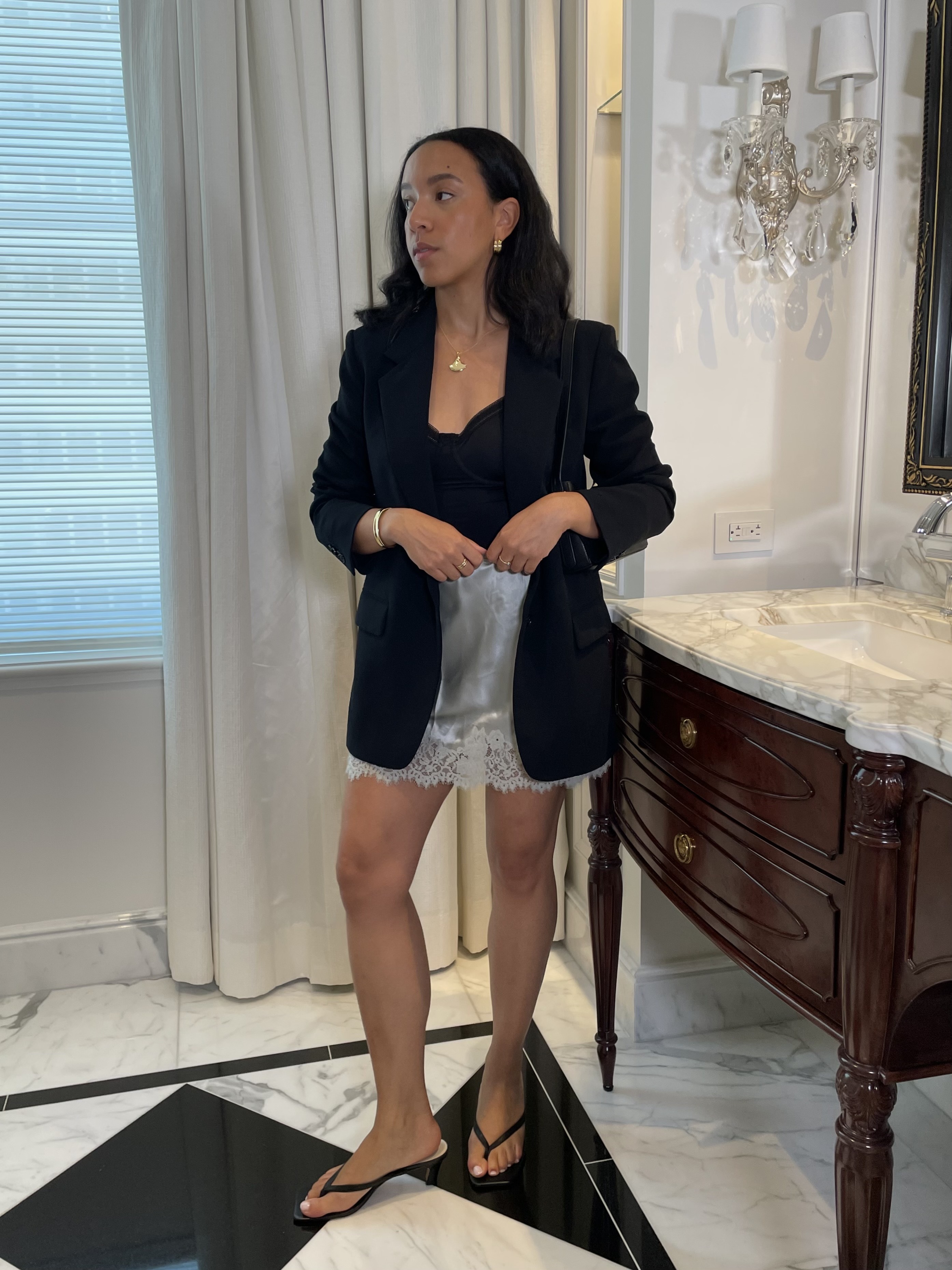Lauren Tappan wearing a blazer, a silver skirt, and black sandals