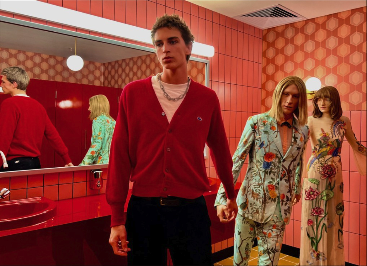 18-year-old posing with two mannequins at a Gucci exhibition in Sydney