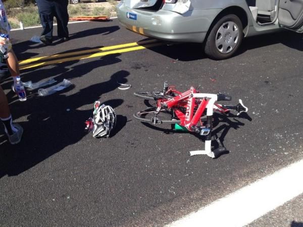 A broken bike lies on the ground