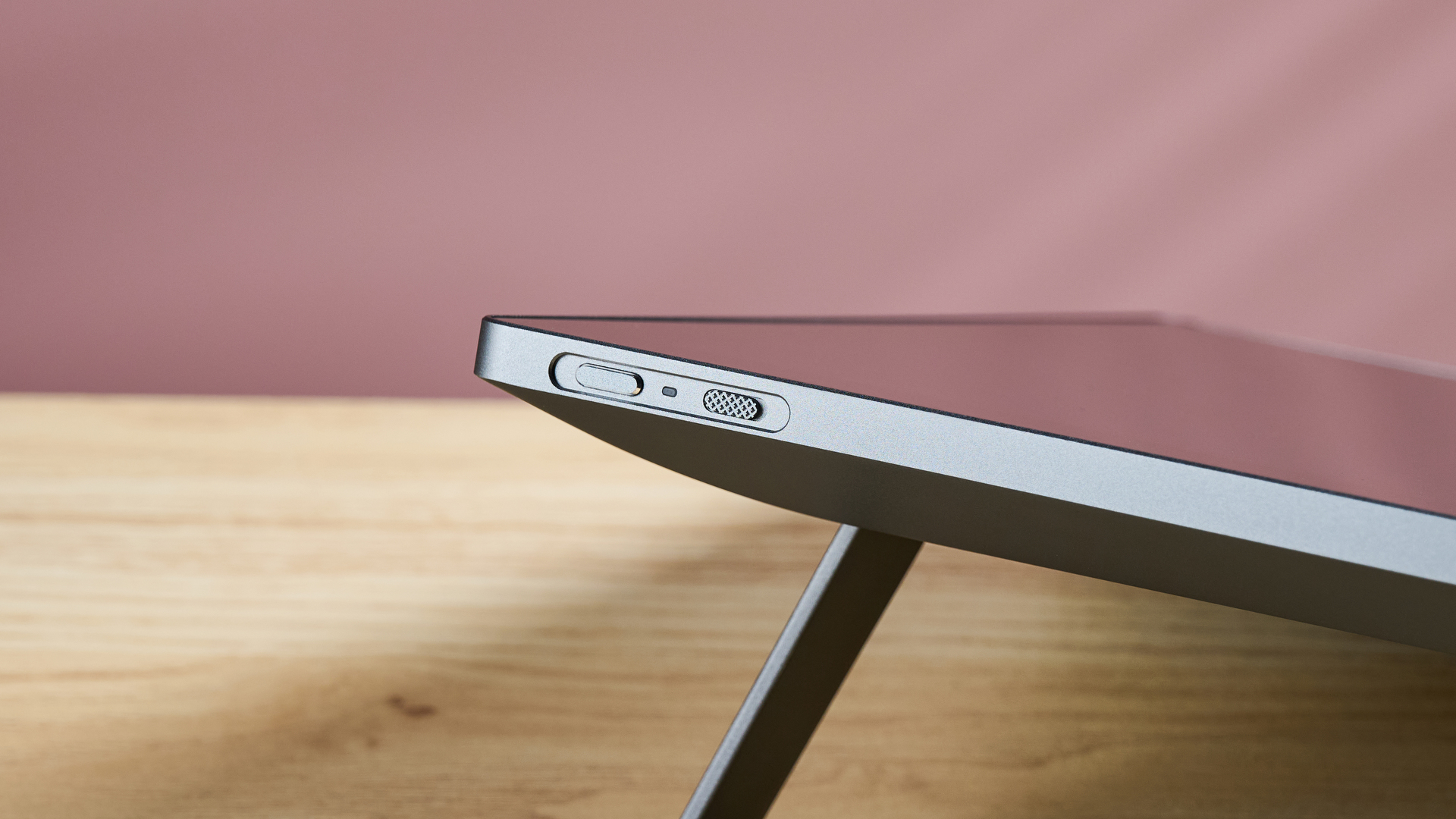The top right corner of the Huion Kamvas Pro 19, showing off its power button and stand.