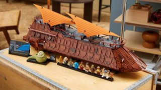 Lego Jabba's Sail Barge set and minifigures laid out on a table