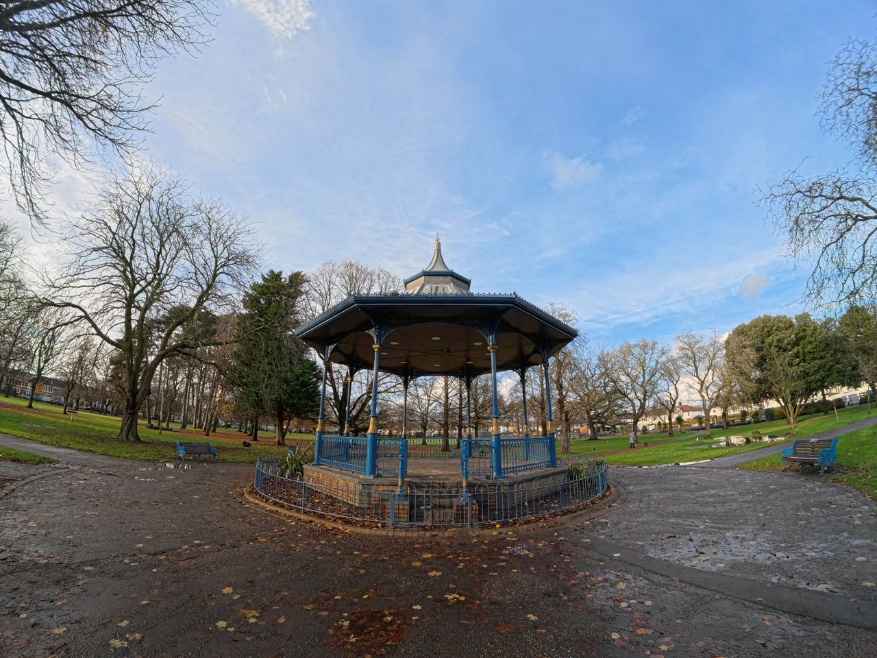 A photo of a pavilion in a park with trees and a blue sky in the background. Shot on the Insta360 Ace Pro in Ultra FoV.