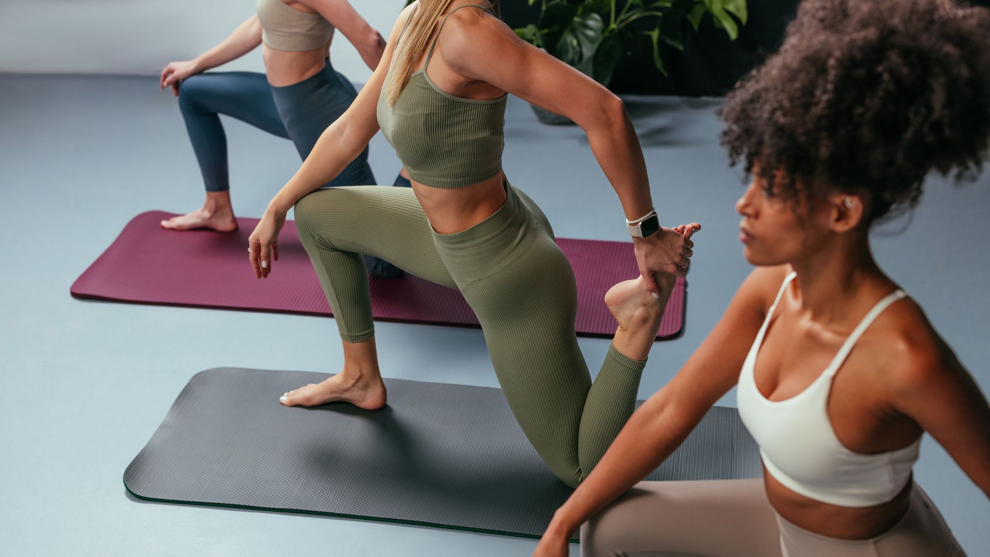 Three women doing 15 minute full body workouts in a studio