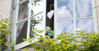 House exterior with a traditional window frame open