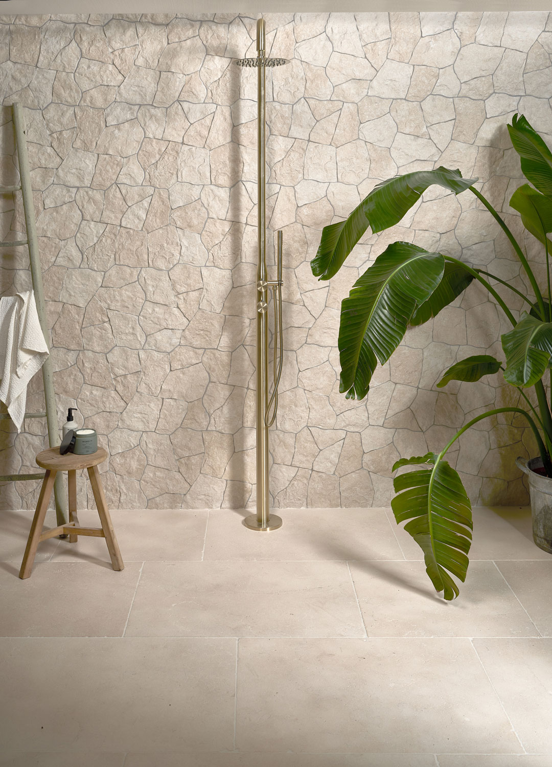 wet room with stone wall tiles and floor mounted shower
