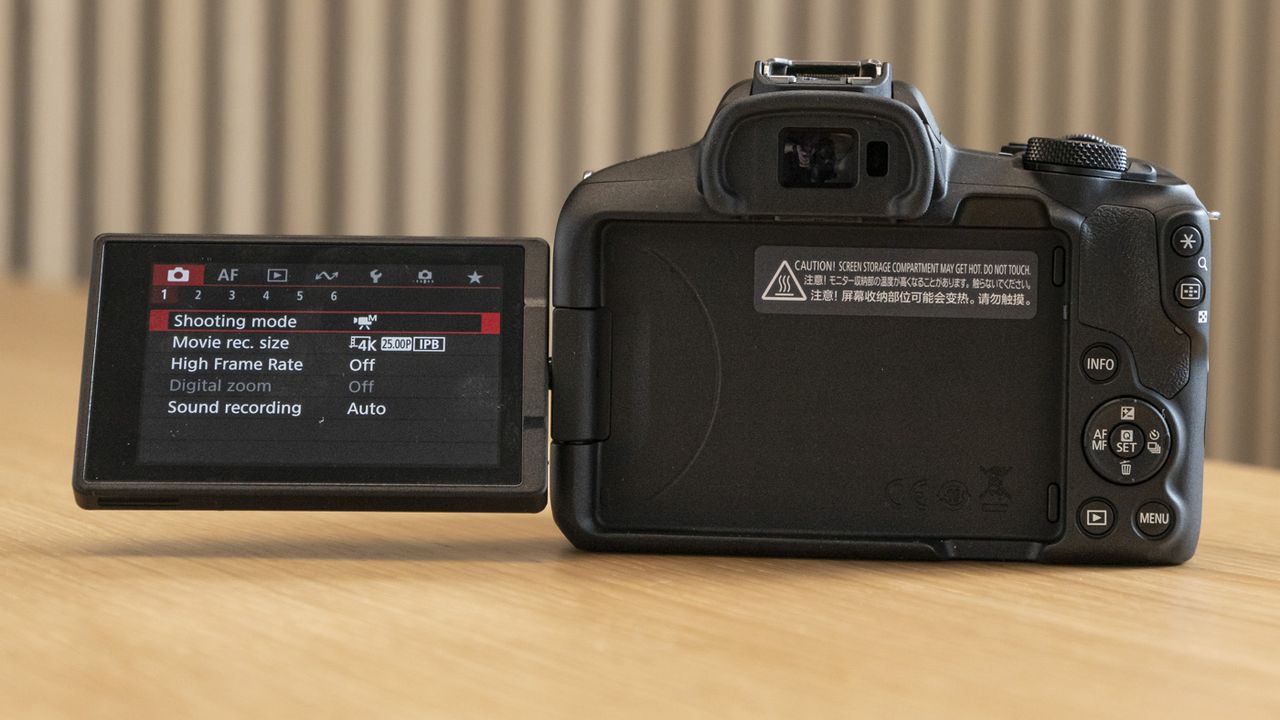 Rear of Canon EOS R50 on a table with screen flipped out