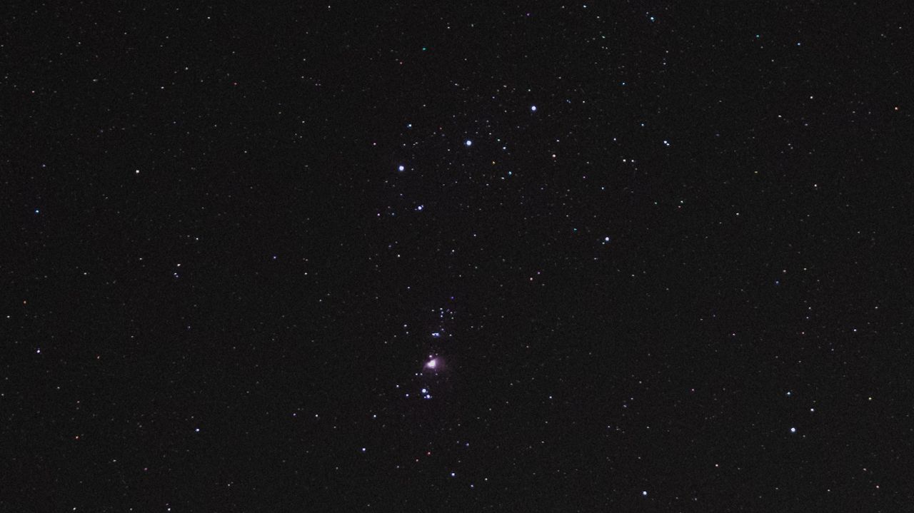 The Orion Nebula and Orion's Belt in the night sky