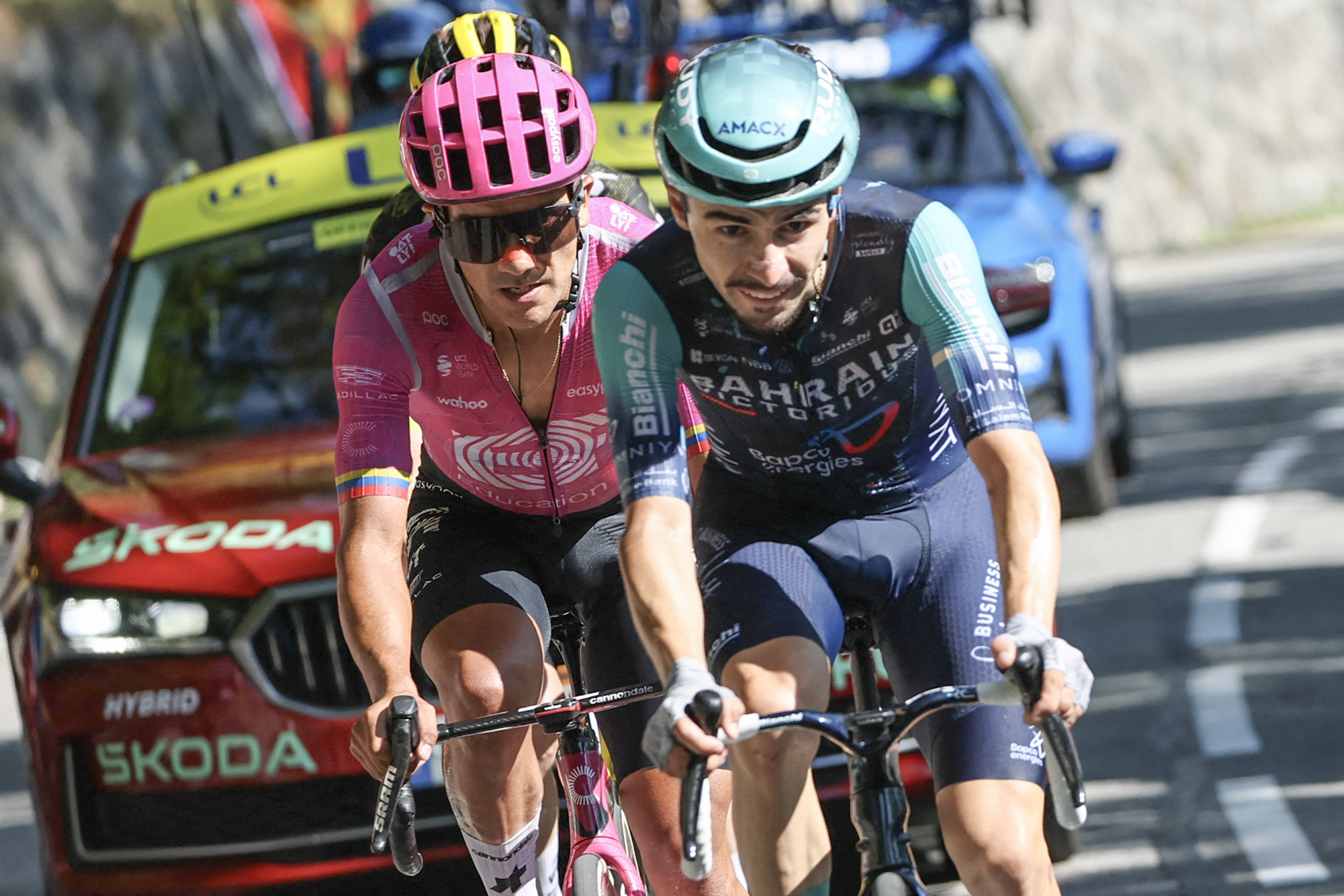 Bahrain - Victorious team's French rider Lenny Martinez (R) and EF Education - EasyPost team's Ecuadorian rider Richard Carapaz cycle in the lead breakaway in the Alpe d'Huez ascent during the 19th stage of the 113th edition of the Tour de France cycling race, 127,9 km between Gap and Alpe d'Huez in the French Alps, on July 24, 2026. (Photo by Anne-Christine POUJOULAT / AFP via Getty Images)