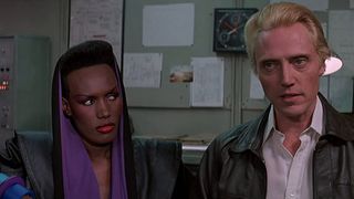 Christopher Walken and Grace Jones talk to someone off camera in A View To A Kill