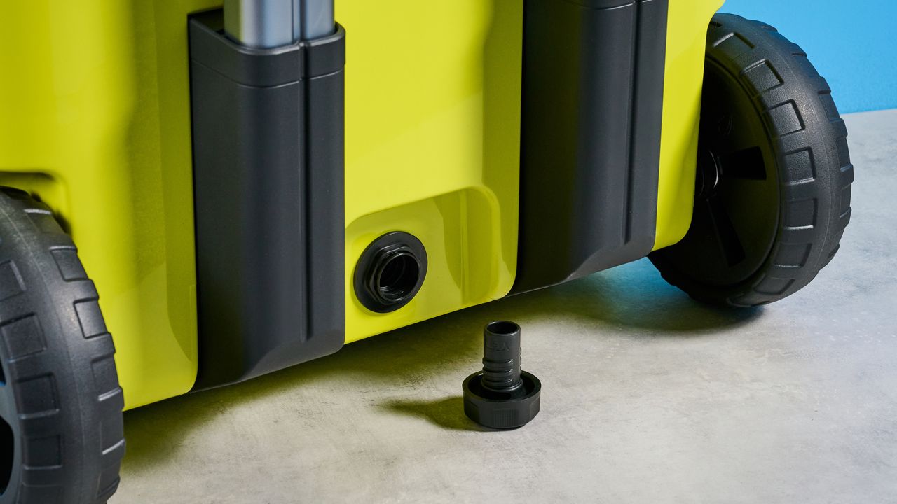 the yeti roader cooler in neon yellow with wheels, soft close hinges, a retractable handle, and 32 quart capacity