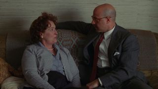 Julia Child, played by Meryl Streep, sits on a couch with her husband played by Stanley Tucci