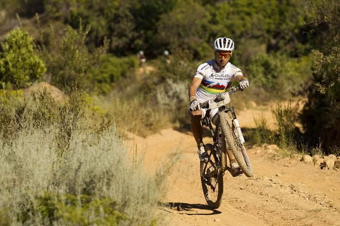 Cross country world champ Nino Schurter of Scott-Swisspower has energy to spare wheelieng up towards Winterhoek