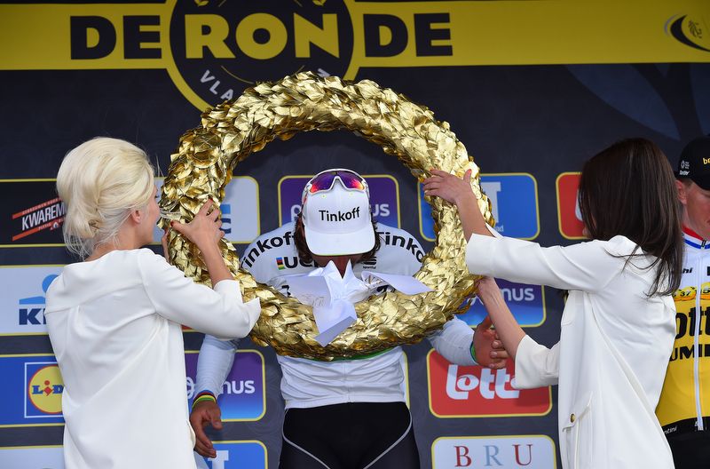 The golden wreath is placed upon Peter Sagan's shoulders