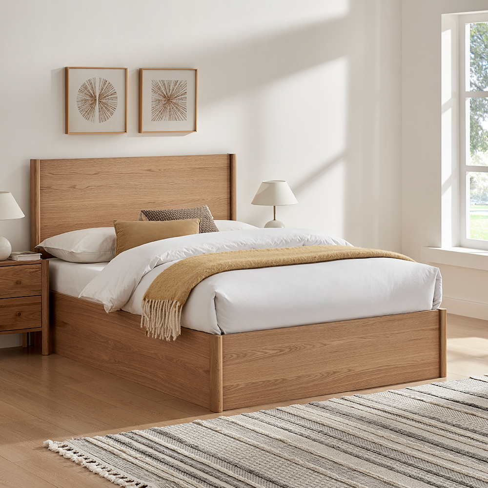 Wooden bed in a white room
