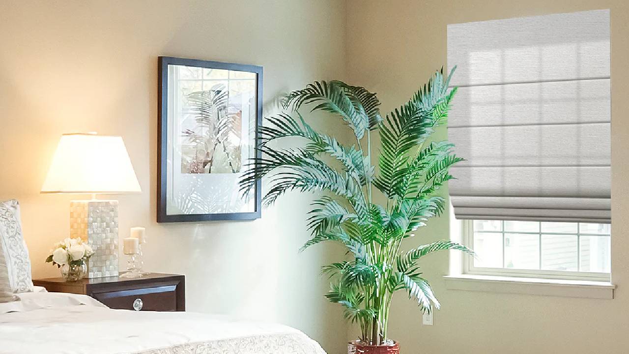 A simple, cream bedroom with a neutral blind in the window from SmartWings Home.