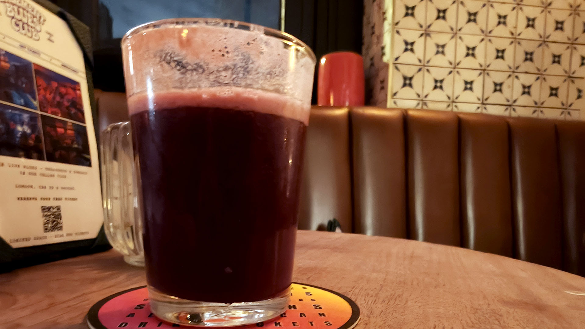 A photo of a glass of sour beer.