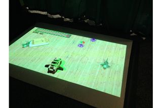 In this Augmented World Expo demo, Lumo beams a game where a real toy car blasts virtual toys as they zoom by.
