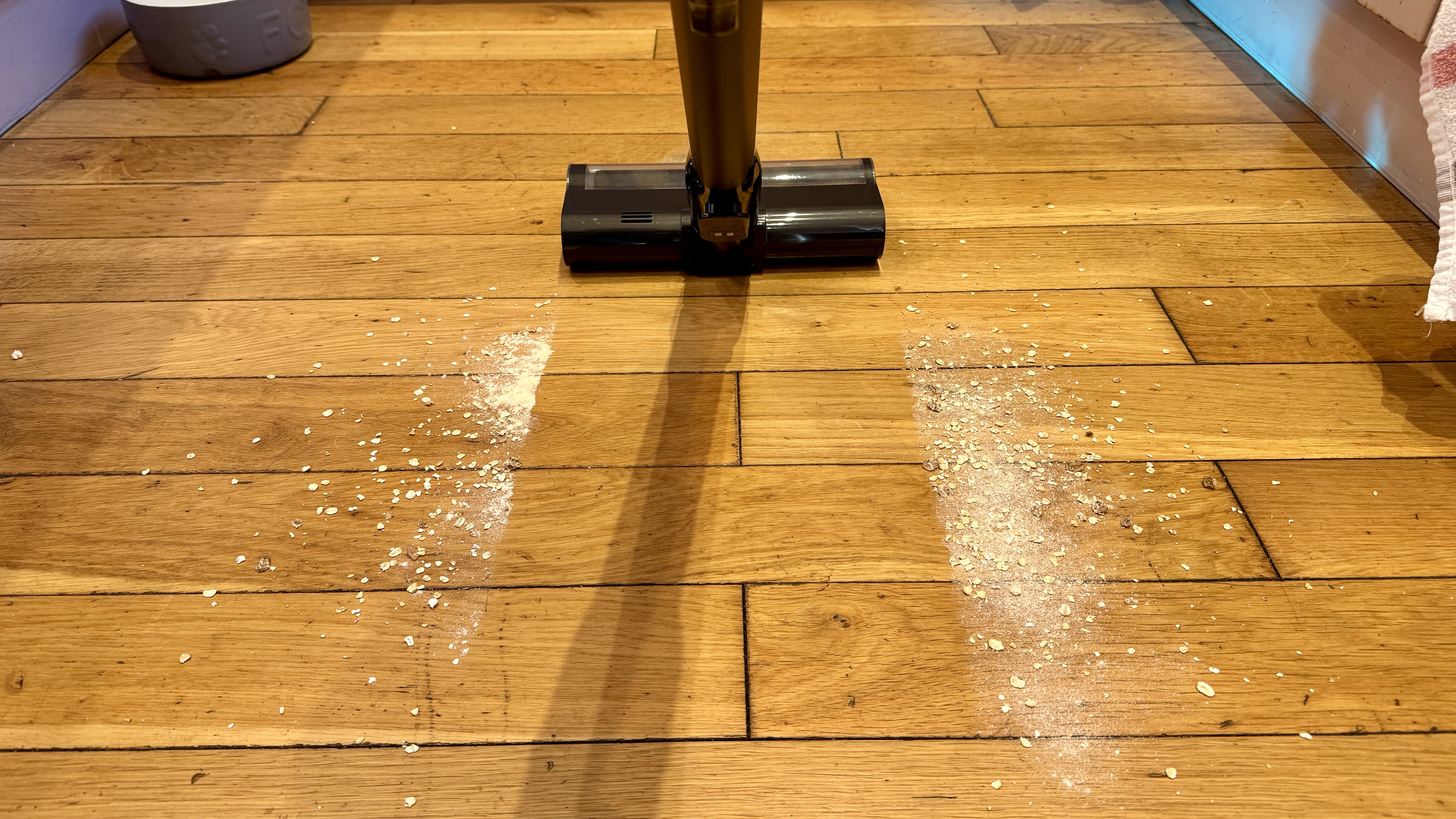 Dreame V20 Pro vacuum cleaning mess from a hard floor