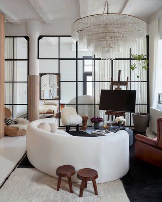 an apartment living room with a large chandelier