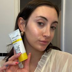 Associate beauty editor Alyssa Brascia holding a drugstore primer and a selfie of her wearing it.