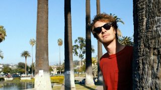 Andrew Garfield lounging in Under the Silver Lake