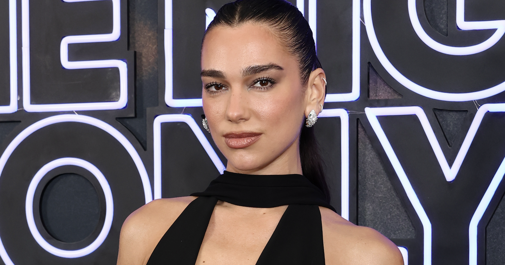 Dua Lipa attends "One Night Only" New York Premiere at SVA Theater on August 03, 2026 in New York City wearing low-cut black gown.