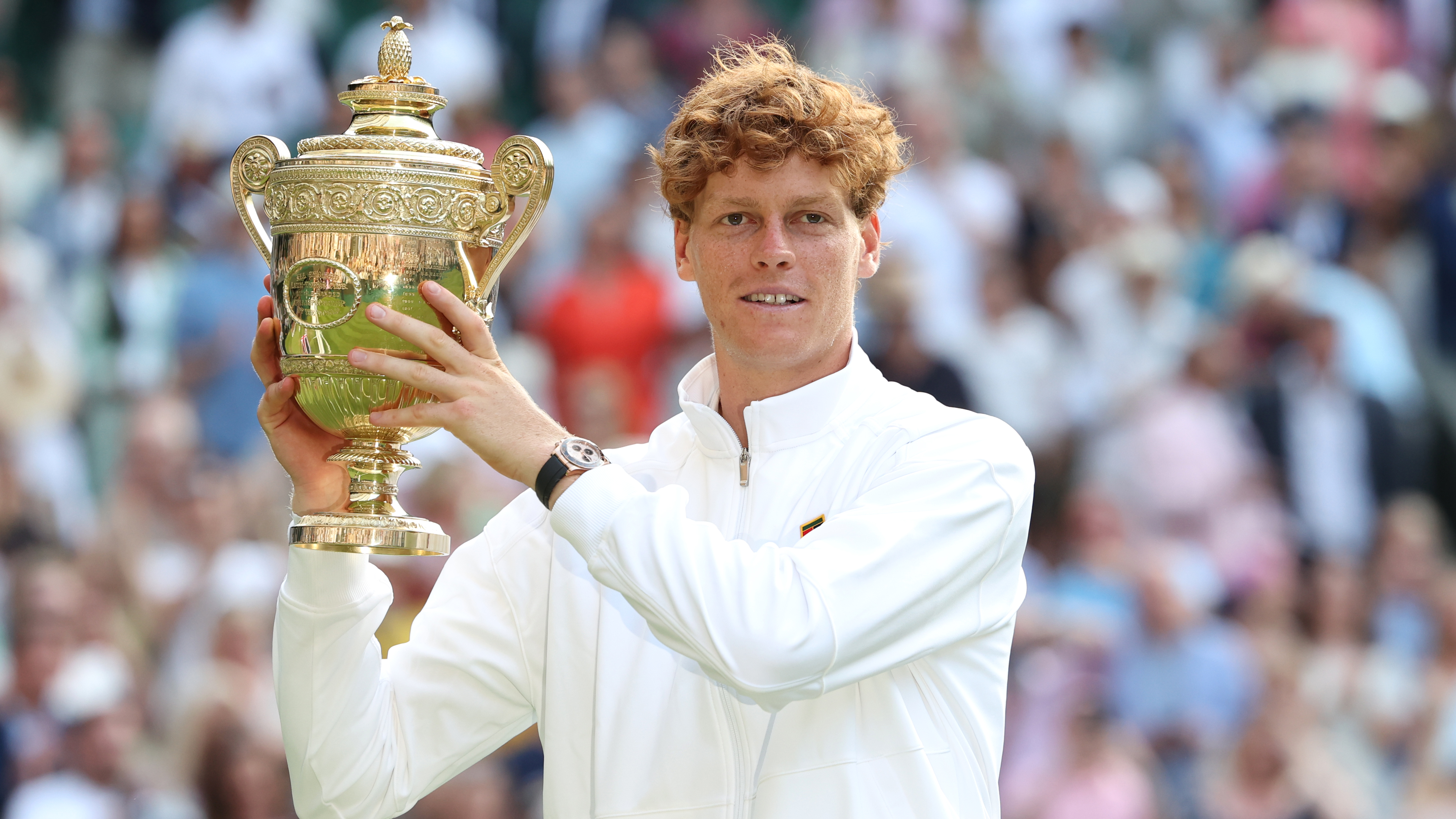 Jannick Sinner with the winner's trophy after winning Wimbledon