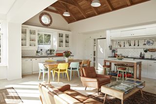open plan kitchen, dining and living room with vaulted ceiling