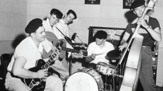 Cliff Gallup (left) performs with Gene Vincent and the Blue Caps in 1956.